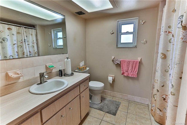 5626 W Justin Ct, Homosassa, FL 34448 - full bathroom featuring decorative backsplash, toilet, tile patterned floors, vanity, and baseboards