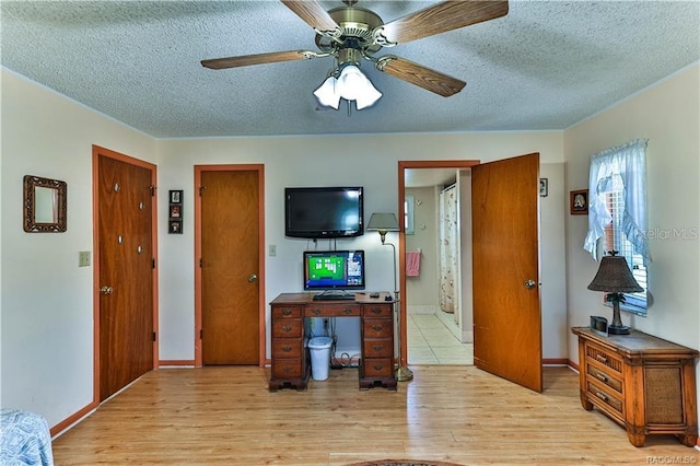5626 W Justin Ct, Homosassa, FL 34448 - living area with a textured ceiling, light wood-style flooring, a ceiling fan, and baseboards