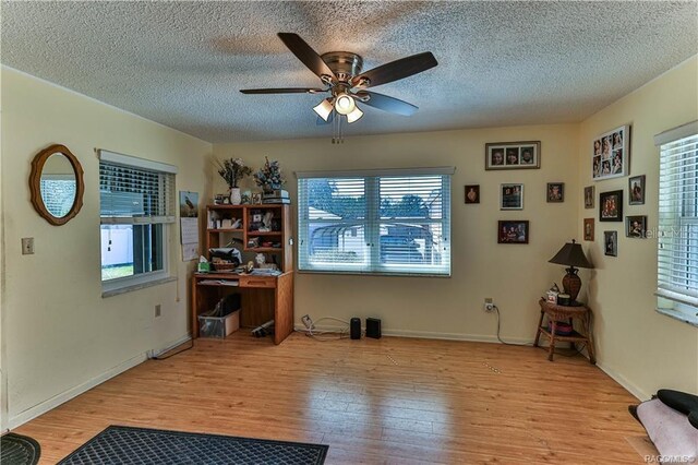 5626 W Justin Ct, Homosassa, FL 34448 - office featuring plenty of natural light, ceiling fan, wood finished floors, a textured ceiling, and baseboards