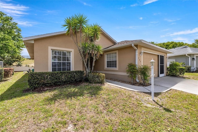785 W Toucan Loop, Hernando, FL 34442 - view of front of property with stucco siding, concrete driveway, a garage, and a front yard