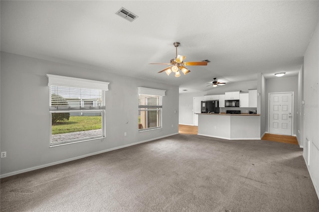785 W Toucan Loop, Hernando, FL 34442 - unfurnished living room with carpet, ceiling fan, baseboards, and lofted ceiling