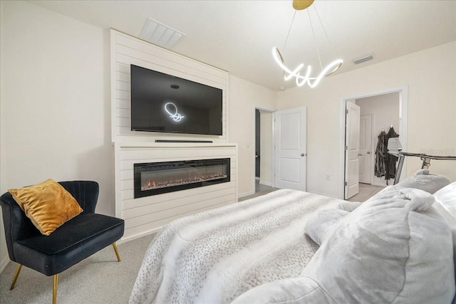 160 Hickory Course Loop, Ocala, FL 34472 - bedroom featuring a chandelier, a large fireplace, and carpet floors