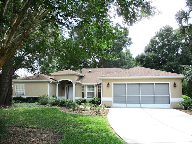 14561 SW 112th Cir, Dunnellon, FL 34432 - single story home featuring an attached garage, driveway, stucco siding, and a front lawn