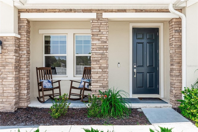 5248 Red Coral Cir, Mount Dora, FL 32757 - doorway to property with covered porch and stucco siding