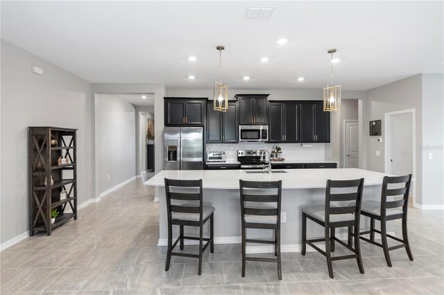 5248 Red Coral Cir, Mount Dora, FL 32757 - kitchen with appliances with stainless steel finishes, light countertops, a large island, dark cabinets, and baseboards