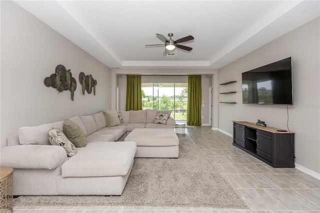 5248 Red Coral Cir, Mount Dora, FL 32757 - living area featuring a ceiling fan, a tray ceiling, and baseboards