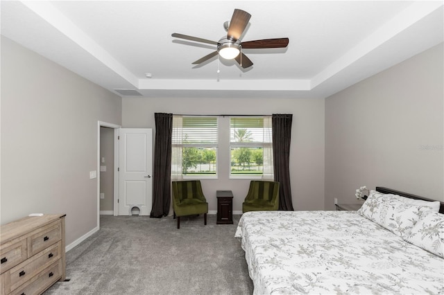 5248 Red Coral Cir, Mount Dora, FL 32757 - bedroom featuring light carpet, a tray ceiling, and baseboards