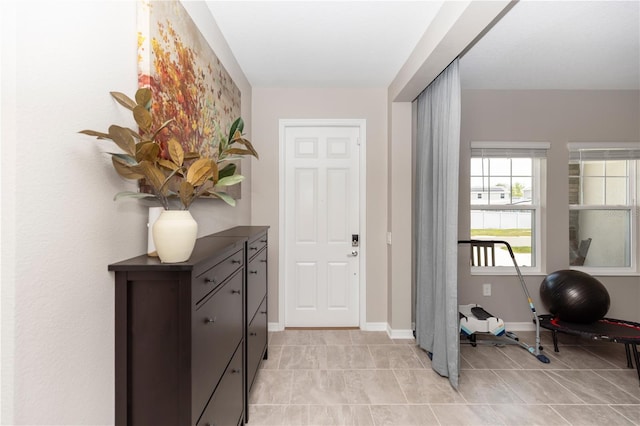 5248 Red Coral Cir, Mount Dora, FL 32757 - foyer featuring light tile patterned floors and baseboards