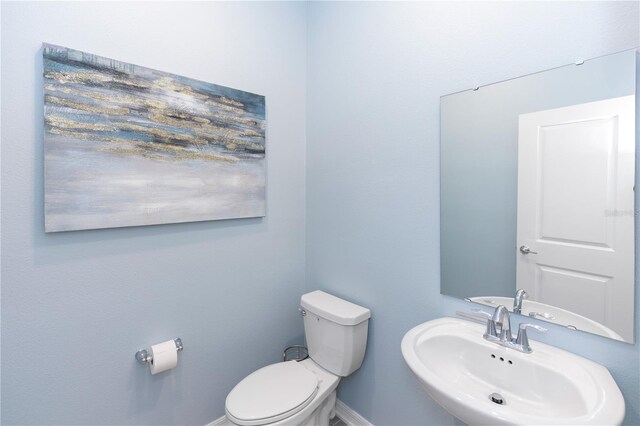 5248 Red Coral Cir, Mount Dora, FL 32757 - bathroom featuring a sink, toilet, and baseboards