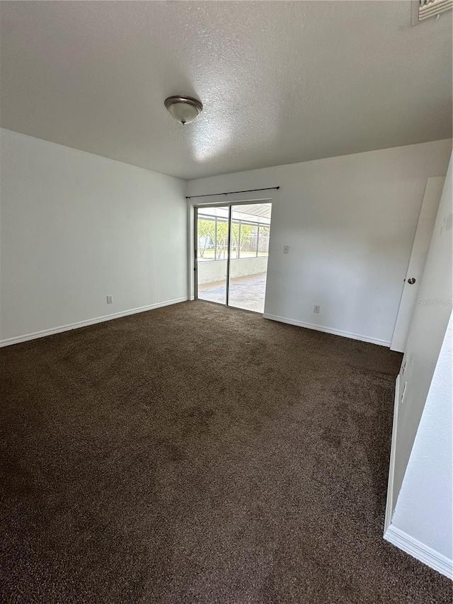 5525 SE 43rd Ct, Ocala, FL 34480 - unfurnished room with dark carpet, baseboards, and a textured ceiling