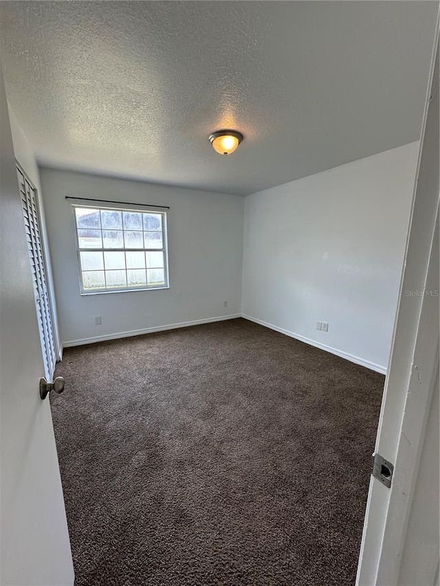 5525 SE 43rd Ct, Ocala, FL 34480 - empty room featuring dark colored carpet, a textured ceiling, and baseboards
