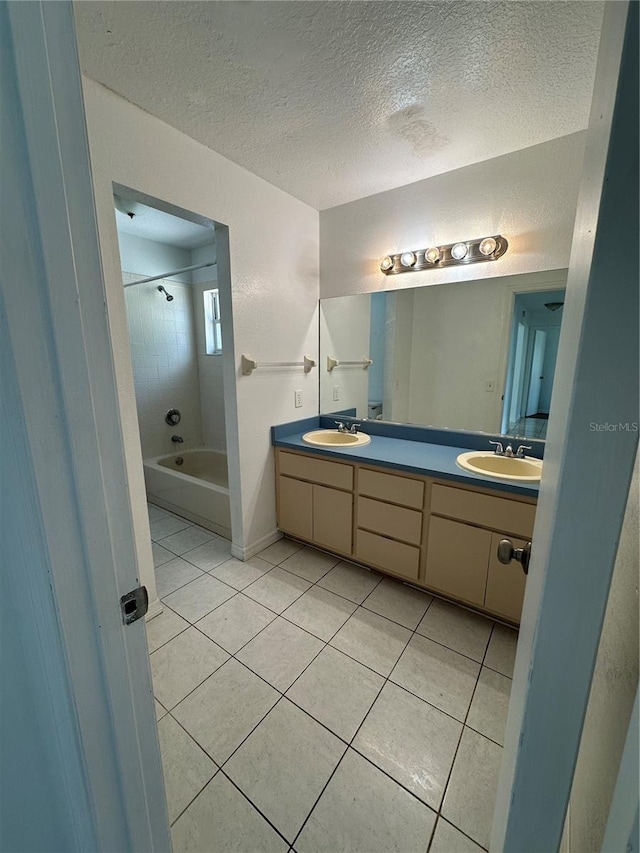 5525 SE 43rd Ct, Ocala, FL 34480 - bathroom with tile patterned flooring, double vanity, a textured ceiling, and washtub / shower combination