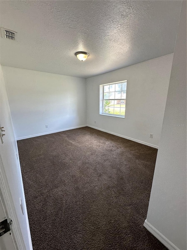 5525 SE 43rd Ct, Ocala, FL 34480 - spare room featuring dark colored carpet, baseboards, and a textured ceiling