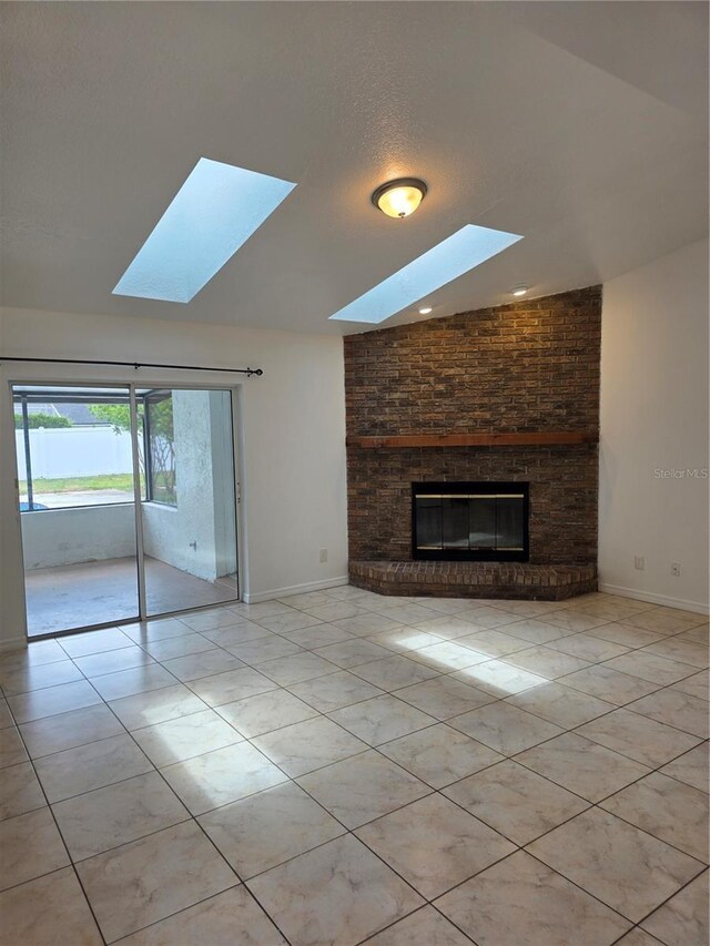 5525 SE 43rd Ct, Ocala, FL 34480 - unfurnished living room featuring a skylight, light tile patterned flooring, a fireplace, and baseboards