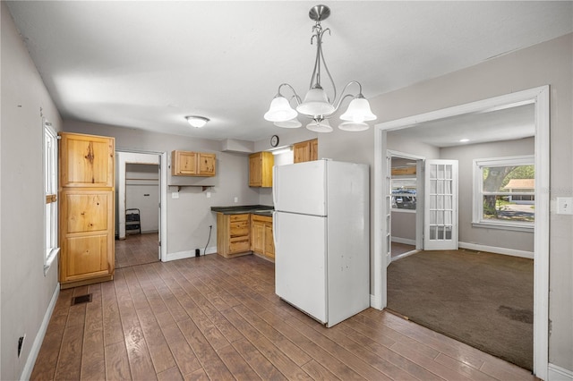 1014 NE 12th St, Ocala, FL 34470 - kitchen featuring freestanding refrigerator, baseboards, and dark wood-type flooring