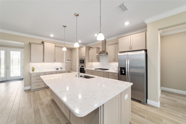 10451 SW 98th Place Rd, Ocala, FL 34481 - kitchen with appliances with stainless steel finishes, a sink, wall chimney range hood, an island with sink, and baseboards