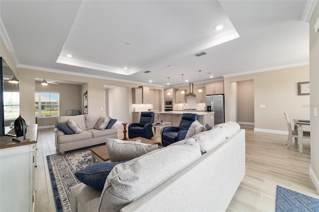 10451 SW 98th Place Rd, Ocala, FL 34481 - living area featuring a raised ceiling, baseboards, ornamental molding, light wood finished floors, and recessed lighting