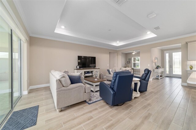 10451 SW 98th Place Rd, Ocala, FL 34481 - living room with a raised ceiling, light wood-style floors, baseboards, crown molding, and recessed lighting