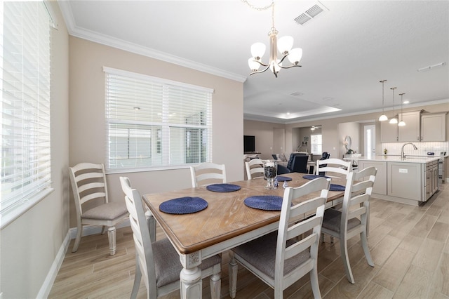 10451 SW 98th Place Rd, Ocala, FL 34481 - dining room featuring crown molding, a chandelier, light wood-style flooring, and plenty of natural light
