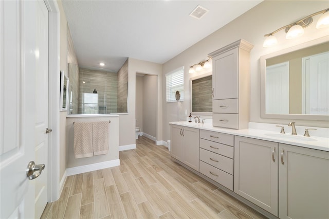 10451 SW 98th Place Rd, Ocala, FL 34481 - full bath featuring double vanity, a walk in shower, wood finished floors, baseboards, and recessed lighting