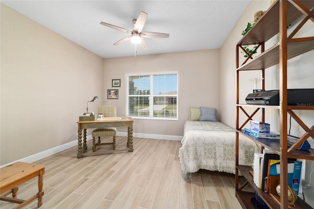 10451 SW 98th Place Rd, Ocala, FL 34481 - bedroom featuring wood finished floors, an office area, baseboards, and a ceiling fan