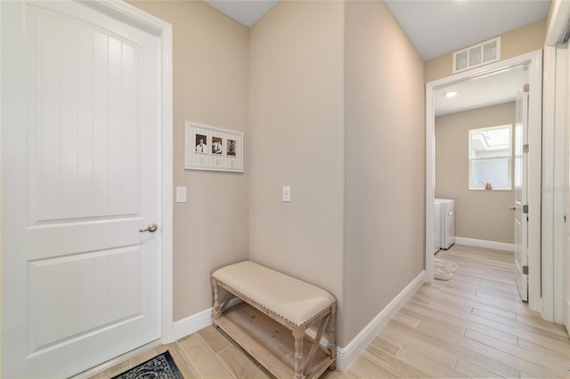 10451 SW 98th Place Rd, Ocala, FL 34481 - mudroom featuring light wood-style floors, baseboards, and independent washer and dryer