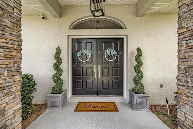 1107 SE 49th Ave, Ocala, FL 34471 - view of exterior entry with stucco siding and a security system