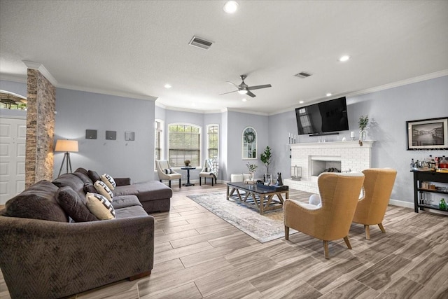 1107 SE 49th Ave, Ocala, FL 34471 - living area featuring a ceiling fan, light wood-style floors, recessed lighting, crown molding, and a brick fireplace