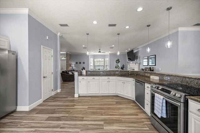1107 SE 49th Ave, Ocala, FL 34471 - kitchen featuring appliances with stainless steel finishes, ornamental molding, open floor plan, white cabinets, and recessed lighting