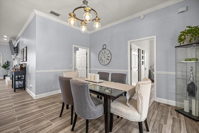 1107 SE 49th Ave, Ocala, FL 34471 - dining space with ornamental molding, wood finished floors, baseboards, and a chandelier