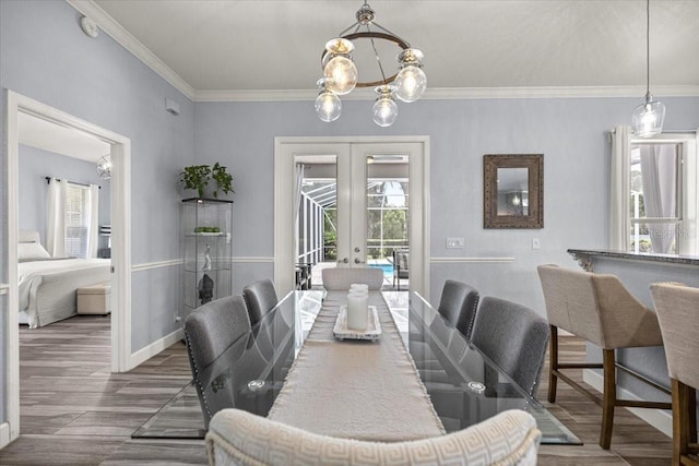 1107 SE 49th Ave, Ocala, FL 34471 - dining space with french doors, a chandelier, ornamental molding, wood finished floors, and baseboards