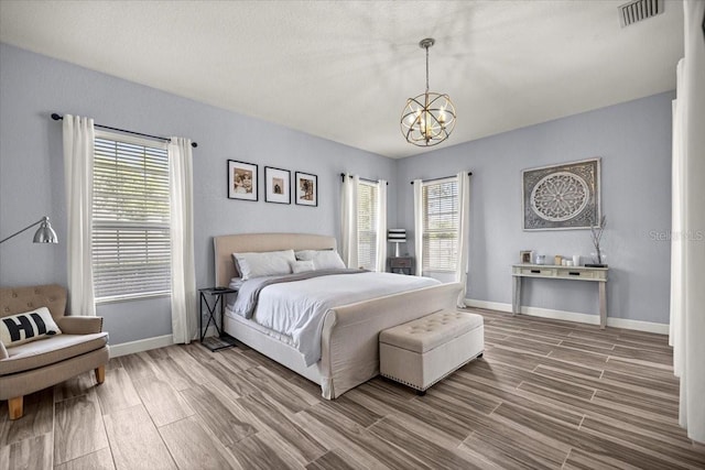 1107 SE 49th Ave, Ocala, FL 34471 - bedroom featuring a chandelier, wood finish floors, and multiple windows