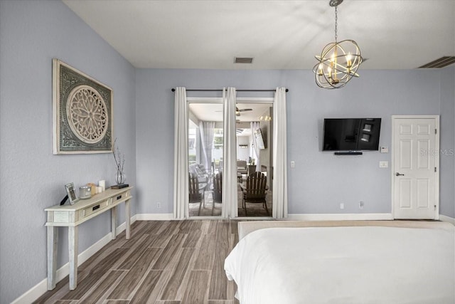 1107 SE 49th Ave, Ocala, FL 34471 - bedroom featuring a chandelier, baseboards, wood finished floors, and access to exterior