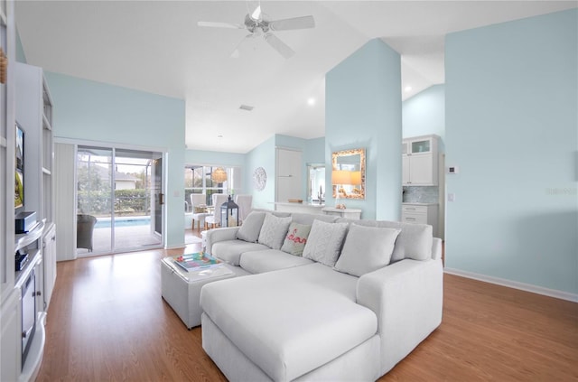 3656 E Lake Todd Dr, Hernando, FL 34442 - living area featuring light wood-type flooring, ceiling fan, high vaulted ceiling, and baseboards