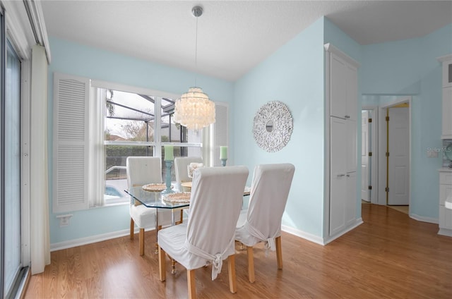 3656 E Lake Todd Dr, Hernando, FL 34442 - dining area featuring light wood-style flooring, a chandelier, and baseboards