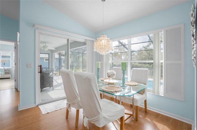 3656 E Lake Todd Dr, Hernando, FL 34442 - dining room with wood finished floors, healthy amount of natural light, vaulted ceiling, baseboards, and a chandelier