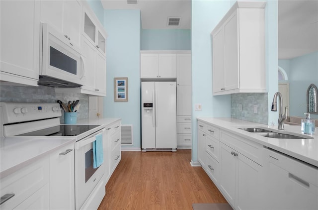 3656 E Lake Todd Dr, Hernando, FL 34442 - kitchen with white appliances, a sink, light countertops, and tasteful backsplash
