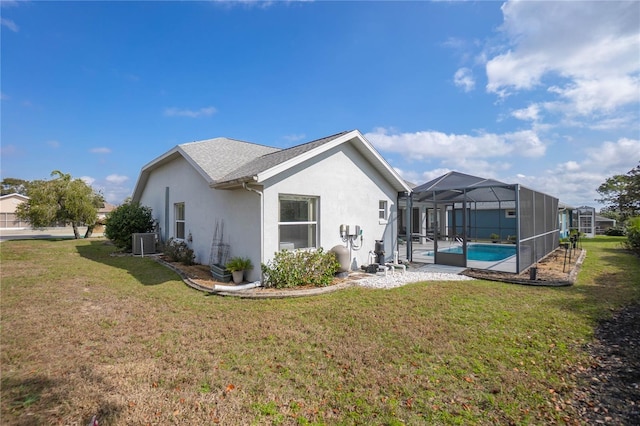 3656 E Lake Todd Dr, Hernando, FL 34442 - rear view of house with stucco siding, central AC, a yard, an outdoor pool, and glass enclosure