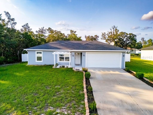 3897 SW 169th Lane Rd, Ocala, FL 34473 - ranch-style house with stucco siding, an attached garage, a front yard, concrete driveway, and roof with shingles