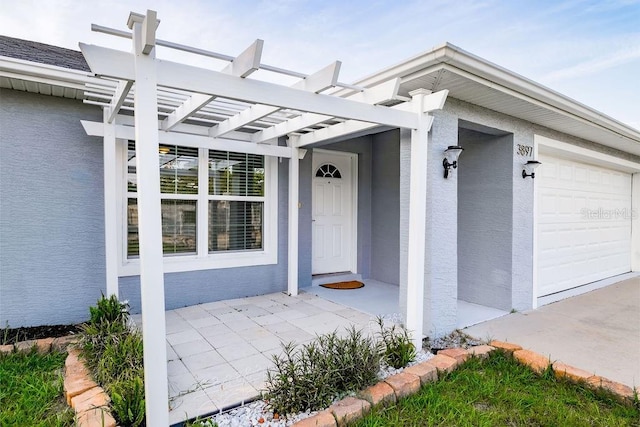 3897 SW 169th Lane Rd, Ocala, FL 34473 - property entrance featuring a pergola, a garage, and stucco siding