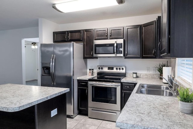 3897 SW 169th Lane Rd, Ocala, FL 34473 - kitchen with stainless steel appliances, a sink, light countertops, and light tile patterned floors