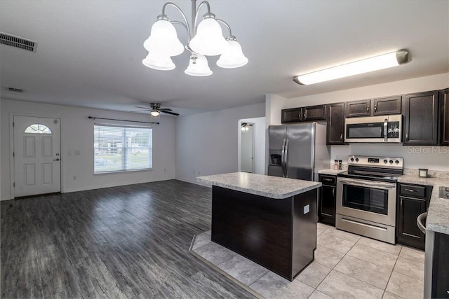 3897 SW 169th Lane Rd, Ocala, FL 34473 - kitchen with stainless steel appliances, a chandelier, light countertops, a center island, and ceiling fan