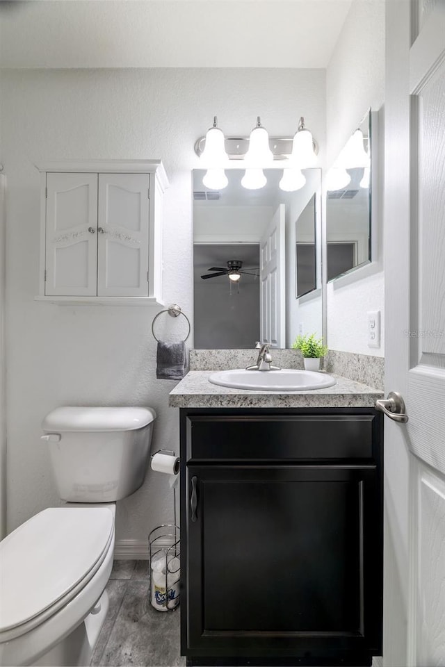 3897 SW 169th Lane Rd, Ocala, FL 34473 - bathroom featuring toilet, vanity, a ceiling fan, and baseboards