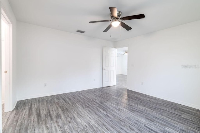 3897 SW 169th Lane Rd, Ocala, FL 34473 - spare room with wood finished floors, a ceiling fan, and baseboards