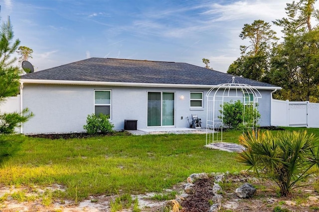 3897 SW 169th Lane Rd, Ocala, FL 34473 - rear view of property with stucco siding, a shingled roof, and a gate