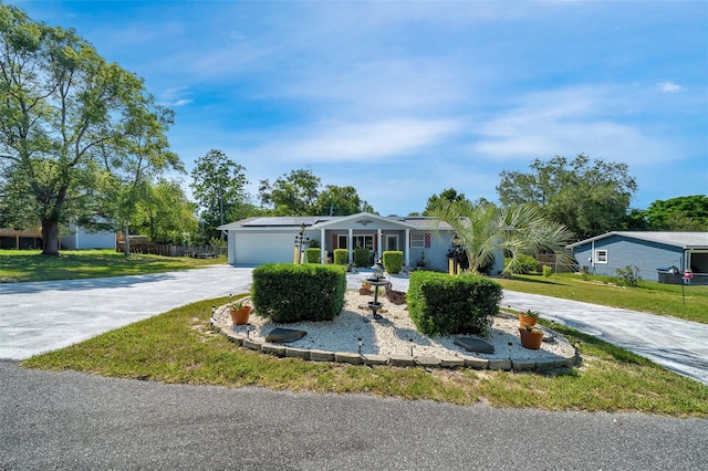 66 S Desoto St, Beverly Hills, FL 34465 - view of front of home featuring concrete driveway, solar panels, a front yard, and a garage
