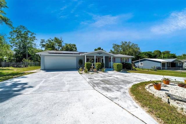 66 S Desoto St, Beverly Hills, FL 34465 - ranch-style house with driveway, an attached garage, solar panels, and covered porch