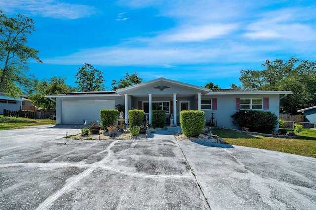 66 S Desoto St, Beverly Hills, FL 34465 - single story home with an attached garage, driveway, and a porch