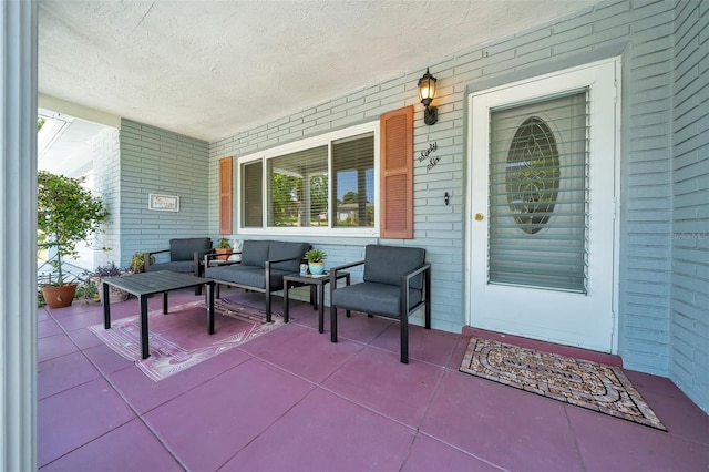 66 S Desoto St, Beverly Hills, FL 34465 - doorway to property with covered porch, brick siding, and an outdoor living space