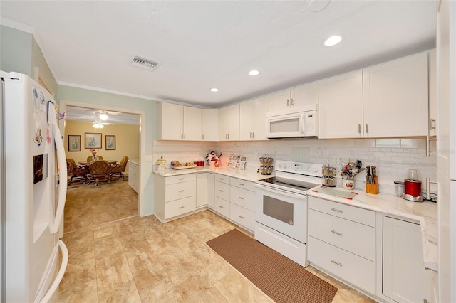 66 S Desoto St, Beverly Hills, FL 34465 - kitchen with white appliances, backsplash, white cabinets, recessed lighting, and ornamental molding